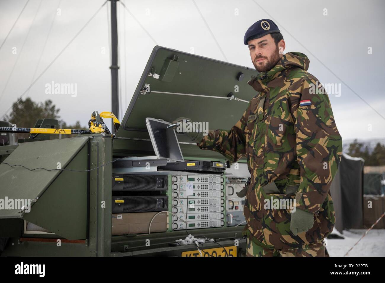 Dutch Sergeant Noordermeer checking the RACE 1 equipment. 1 German/Netherlands Corps' Communication and Information Systems Battalion is responsible for the communication between the Headquarters and its brigades. RACE 1 provides the CIS link between 1GNC as LCC and the Italian Ariete Brigade for Exercise Trident Juncture.    With around 50,000 personnel participating in Trident Juncture 2018, it is one of the largest NATO exercises in recent years. Around 250 aircraft, 65 vessels and more than 10,000 vehicles are involved in the exercise in Norway. Stock Photo