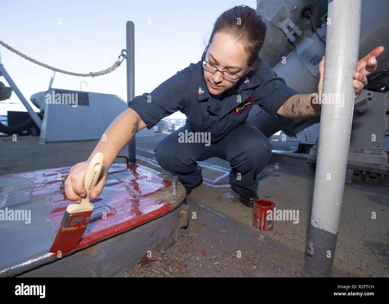 MEDITERRANEAN SEA (Oct. 29, 2018) Fire Controlman 2nd Class Katherine Domenico primes a deck hatch aboard the Arleigh Burke-class guided-missile destroyer USS Arleigh Burke (DDG 51) in the Mediterranean Sea Oct. 29, 2018. Arleigh Burke, homeported at Naval Station Norfolk, is conducting naval operations in the U.S. 6th Fleet area of operations in support of U.S. national security interests in Europe and Africa. Stock Photo