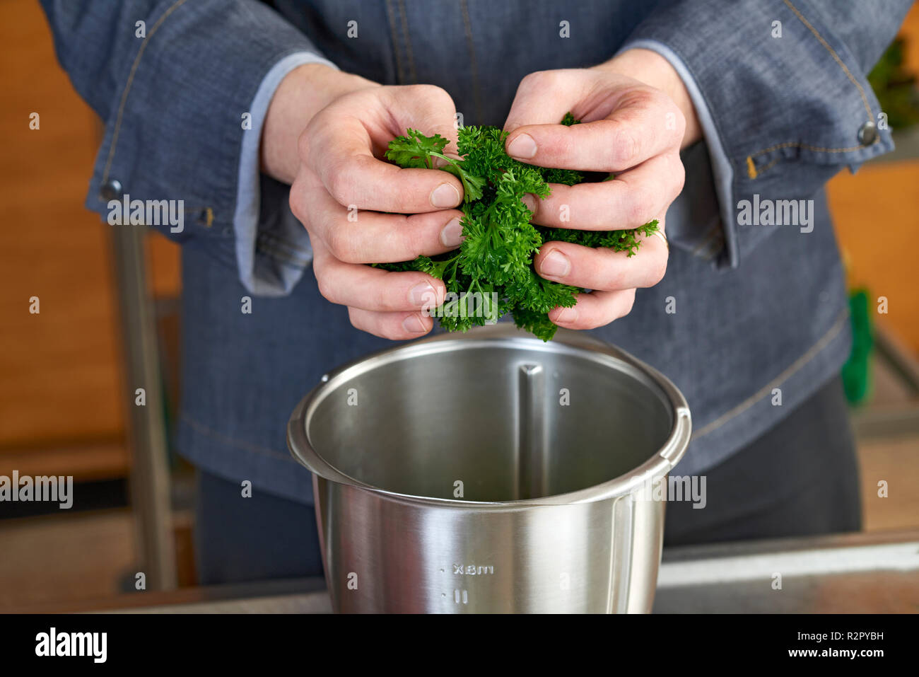 Photo series, step-by-step preparation of a leg of lamb stuffed with herbs and Provençal vegetables by using a food processor (Thermomix ® and Varoma ®), preparing the herb filling Stock Photo