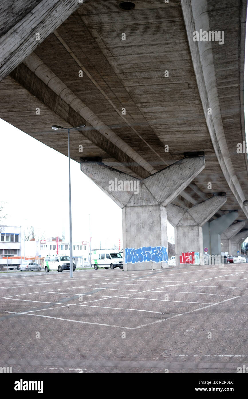 Parking lot, fenced in, under a bridge, city Stock Photo Alamy
