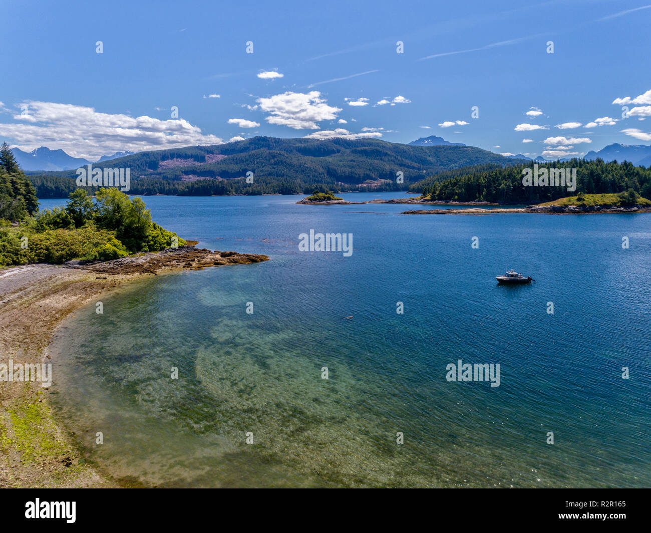 The Ambient Light tour boat near a beach inside the Broughton Archipelago Marine Park, First Nations Territory, British Columbia, Canada Stock Photo