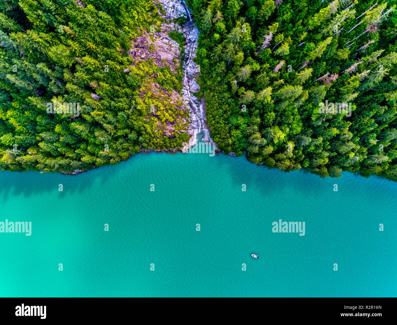 Aerial photograph of a non name waterfall and the 'Ambient Light' tour boat in Knight Inlet, First Nations Territory, British Columbia, Canada Stock Photo
