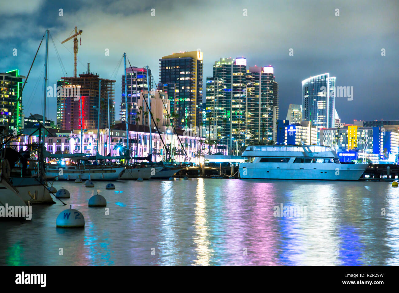 Beautiful San Diego California skyline at harbor seen at night with bay and boats Stock Photo