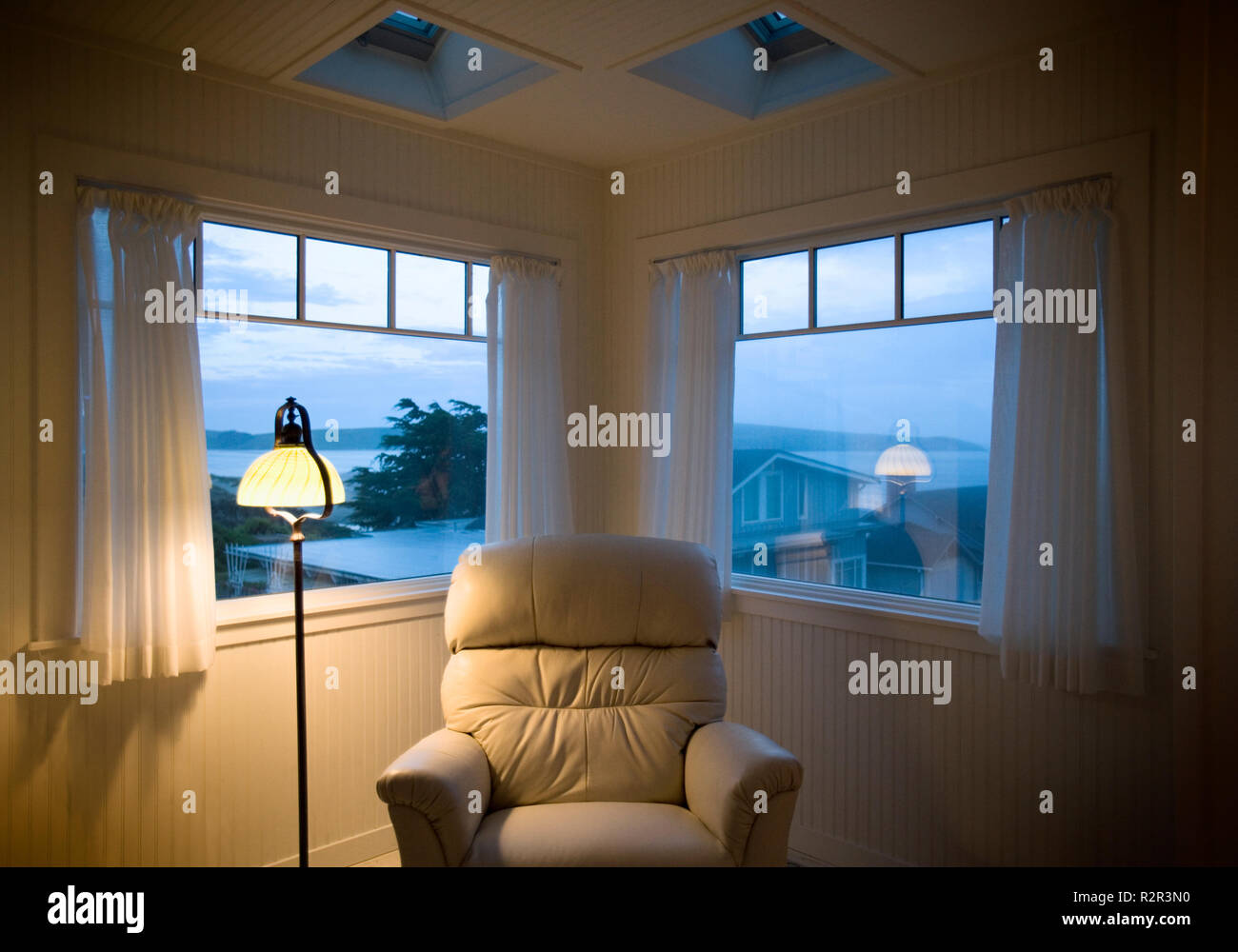 View of a cushioned chair in a room. Stock Photo