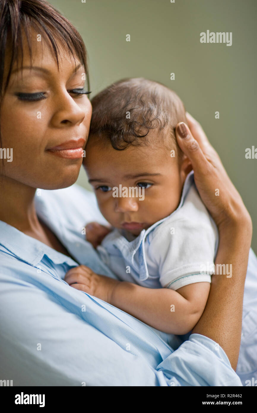 Mid-adult woman holding her young baby. Stock Photo