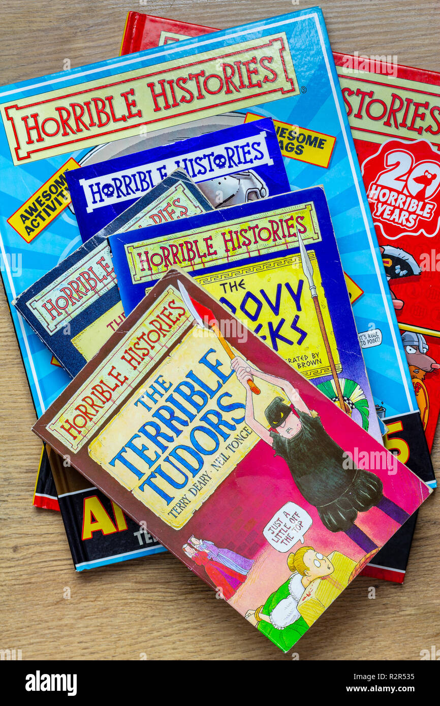 A stack of well read Horrible Histories children’s book by Terry Deary illustrated by Martin Brown Stock Photo