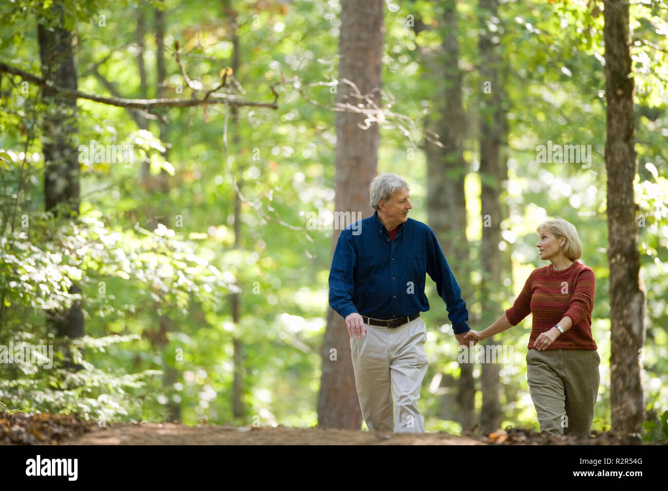 Couple going for a walk in the woods Stock Photo - Alamy
