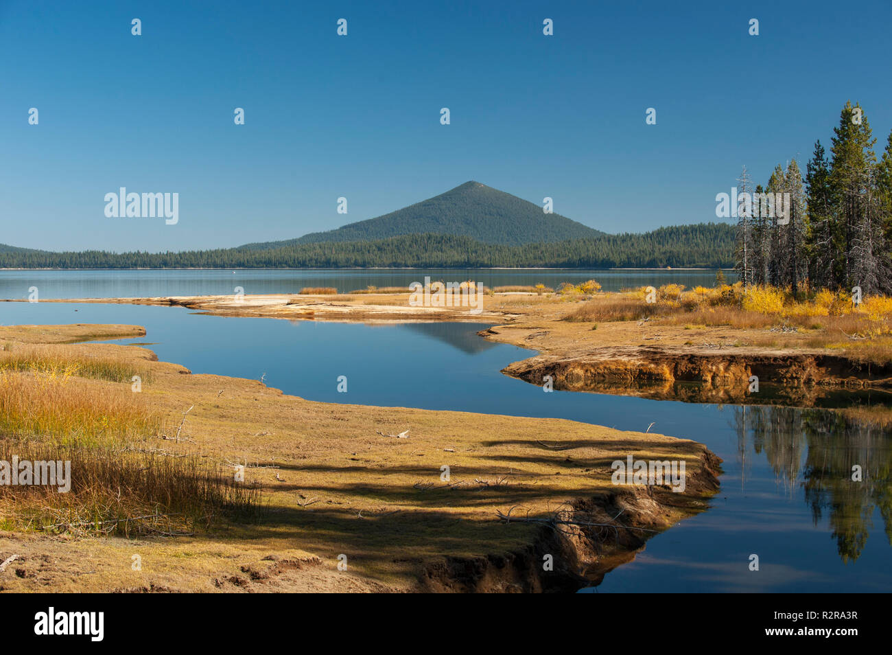 Odell Butte, a cinder cone, rises above Crescent Lake in Oregon's Cascade Lakes area. Stock Photo