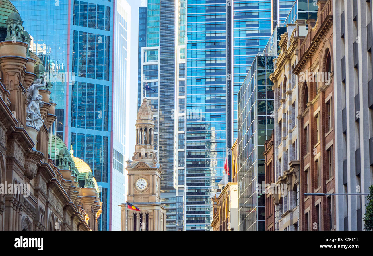 Clock tower of Sydney Town Hall and contrasting architectural styles of modern and old buildings in Sydney NSW Australia. Stock Photo