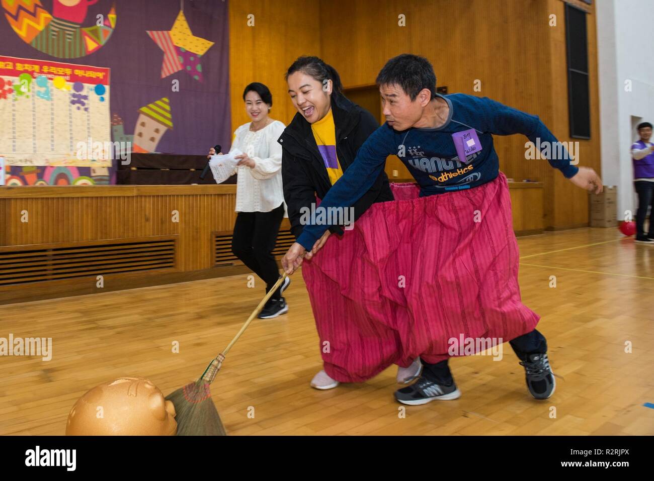 KOJE-DO, Republic of Korea (Nov. 03, 2018) A Sailor participates in a community relations event with a resident of the Aikwangwon Home and School for the Mentally and Physically Disabled in Koje-do. The U.S. Navy and Aikwangwon community outreach program spans more than 60 years and began when U.S. Navy doctors and nurses assigned to the U.S. Navy base in Chinhae volunteered at the home during the Korean War. Stock Photo