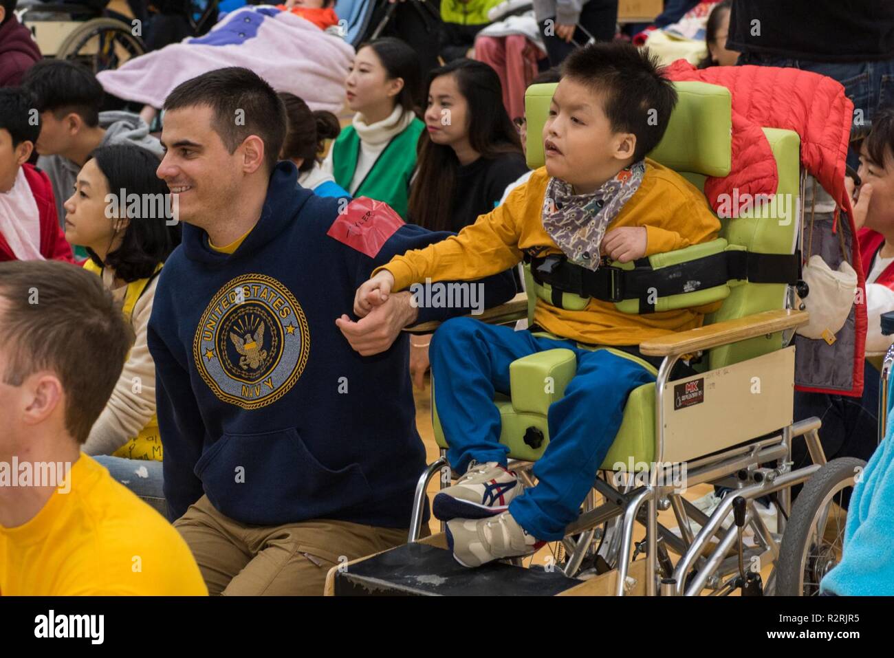 KOJE-DO, Republic of Korea (Nov. 03, 2018) Operations Specialist 2nd Class Tyler Whitney, assigned to Commander, U.S. Naval Forces Korea, participates in a community relations event with residents of the Aikwangwon Home and School for the Mentally and Physically Disabled in Koje-do. The U.S. Navy and Aikwangwon community outreach program spans more than 60 years and began when U.S. Navy doctors and nurses assigned to the U.S. Navy base in Chinhae volunteered at the home during the Korean War. Stock Photo