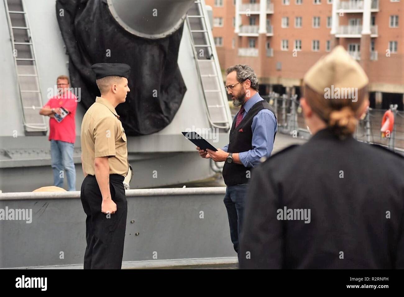 The Hampton Roads Naval Museum hosted a re-enlistment ceremony last week aboard the USS Wisconsin (BB 64). CTR1(IW/EXW/SE) Maxwell T. Crews re-enlisted in-front of members of his command and family, in front of the Wisconsin’s turret #1.  The Wisconsin is one of four Iowa-Class Battleships, and is moored permanently next to the museum as a museum ship. It is a popular venue for military ceremonies, and is available to area commands through the Hampton Roads Naval Museum. To inquire, contact their Special Events Coordinator at Thomas.Dandes@navy.mil or at (757) 322-3106. Stock Photo