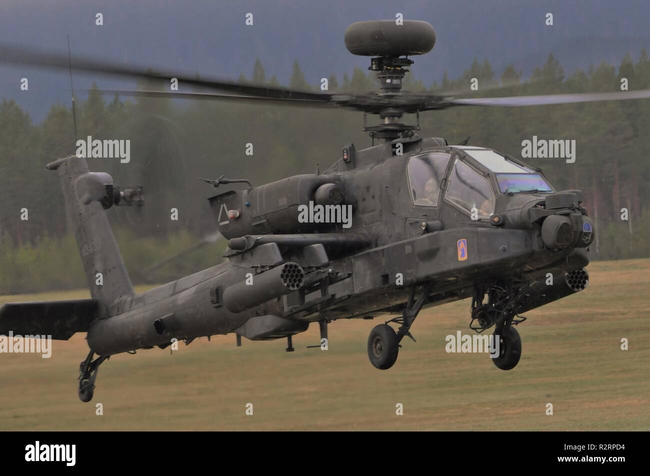 A U.S. Army Apache helicopter assigned to the 1st Battalion, 3rd Aviation Regiment, 12th Combat Aviation Brigade departs Rena Leir Airfield, Norway, during Trident Juncture 18, Nov. 5, 2018. Trident Juncture is a NATO-led military exercise held in Norway. The exercise is the largest of its kind in Norway since the 1980s. An expected 51,000 participants from over 30 nations will take part, including 10,000 vehicles, 150 aircraft and 60 vessels. The main goals of Trident Juncture is to train the NATO Response Force and to test the alliance's defense capabilities. Stock Photo