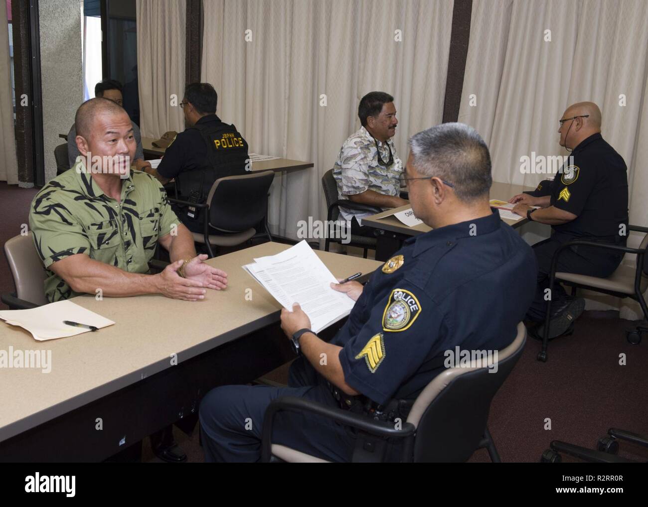 HONOLULU (Nov. 5, 2018) Spencer Kam, of Pearl City, Hawaii, answers  questions during an interview for a security guard position at a job fair  held at the Federal Fire Department on Joint