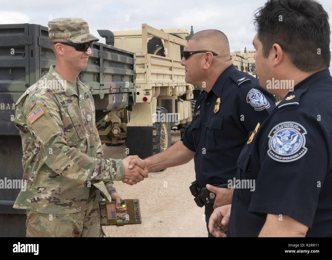 2nd Lt. Paul Whiteman, a Prince George County, Virginia native and engineer platoon leader with the 887th Engineer Support Company, 19th Engineer Battalion, shakes hands with Port Director Jorge Galvan and supervisory Customs and Border Patrol officer Victor Garcia after showing them the life sustainment base, Nov. 5 in Donna, Texas. U.S Northern Command is providing military support to the Department of Homeland Security and U.S. Customs and Border Protection to secure the southern border of the United States. Stock Photo