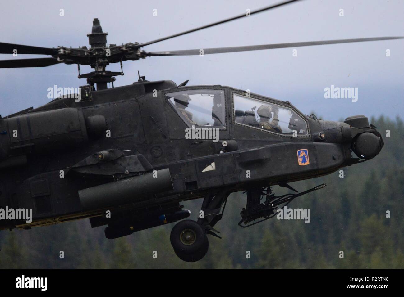 A U.S. Army Apache helicopter assigned to the 1st Battalion, 3rd Aviation Regiment, 12th Combat Aviation Brigade departs Rena Leir Airfield, Norway, during Trident Juncture 18, Nov. 7, 2018. Trident Juncture is a NATO-led military exercise held in Norway. The exercise is the largest of its kind in Norway since the 1980s. An expected 51,000 participants from over 30 nations will take part, including 10,000 vehicles, 150 aircraft and 60 vessels. The main goals of Trident Juncture is to train the NATO Response Force and to test the alliance's defense capabilities. Stock Photo