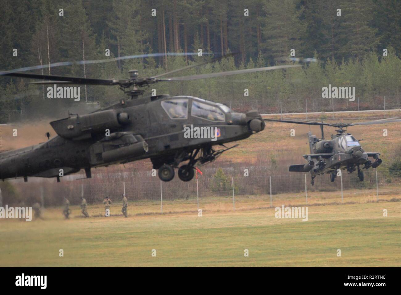 U.S. Army Apache helicopters assigned to the 1st Battalion, 3rd Aviation Regiment, 12th Combat Aviation Brigade depart Rena Leir Airfield, Norway, during Trident Juncture 18, Nov. 7, 2018. Trident Juncture is a NATO-led military exercise held in Norway. The exercise is the largest of its kind in Norway since the 1980s. An expected 51,000 participants from over 30 nations will take part, including 10,000 vehicles, 150 aircraft and 60 vessels. The main goals of Trident Juncture is to train the NATO Response Force and to test the alliance's defense capabilities. Stock Photo