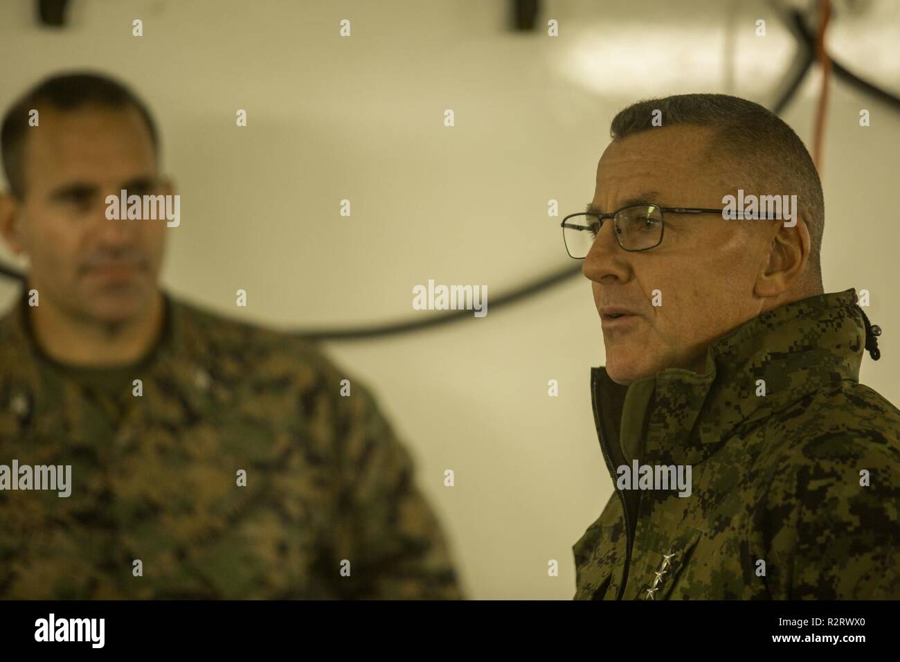 U.S. Marine Corps Lt. Gen. Robert F. Hedelund, the commanding general of II Marine Expeditionary Force speaks with Marines during Exercise Trident Juncture 18 at Vaernes Air Station, Norway, Nov. 7, 2018. Trident Juncture 18 enhances the U.S. and NATO Allies’ and partners’ abilities to work together collectively to conduct military operations under challenging conditions. Stock Photo