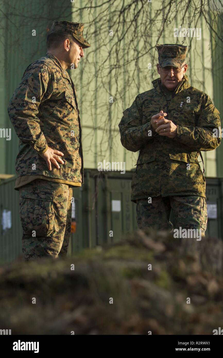 U.S. Marine Corps Lt. Gen. Robert F. Hedelund (right), the commanding general of II Marine Expeditionary Force, speaks with Col. Frank Latt with 2nd Marine Aircraft Wing during Exercise Trident Juncture 18 at Vaernes Air Station, Norway, Nov. 7, 2018. Trident Juncture 18 enhances the U.S. and NATO Allies’ and partners’ abilities to work together collectively to conduct military operations under challenging conditions. Stock Photo