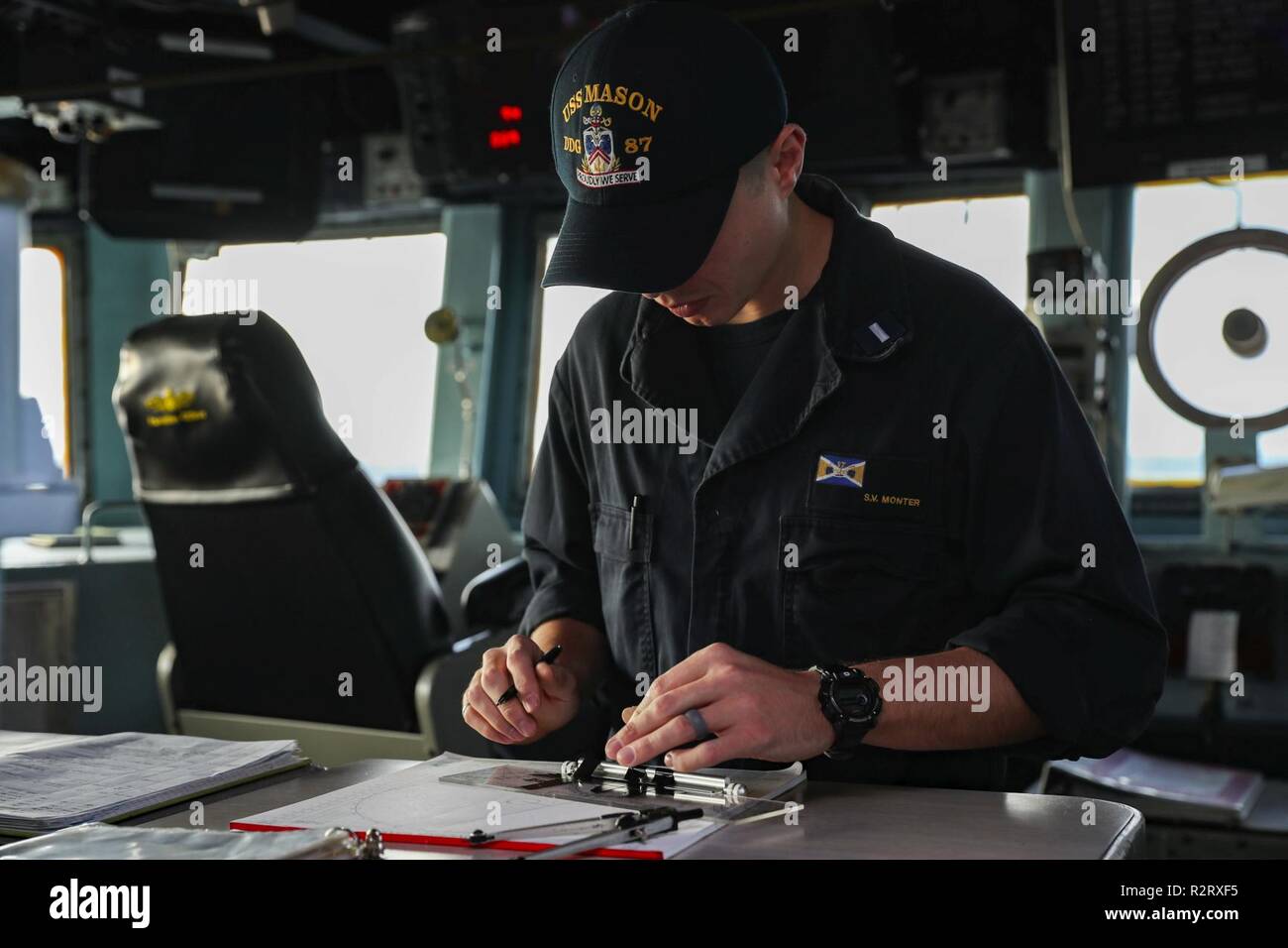 ATLANTIC OCEAN (Nov. 4. 2018) Lt. j.g. Scott Monter uses a maneuvering board to log contacts’ true course and true speed on the bridge aboard the guided-missile destroyer USS Mason (DDG 87). USS Abraham Lincoln (CVN 72) Carrier Strike Group (CSG) cruiser-destroyer (CRUDES) units are completing the first east coast CRUDES Surface Warfare Advanced Tactical Training (SWATT) exercise. SWATT is led by the Naval Surface and Mine Warfighting Development Center (SMWDC) and is designed to increase warfighting proficiency, lethality, and interoperability of participating units. Stock Photo