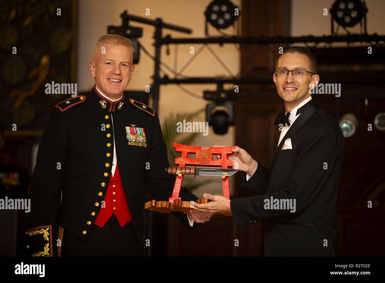 U.S. Marine Corps Brig. Gen. Paul J. Rock Jr., left, commanding general, Marine Corps Installations Pacific, presents a gift to guest of honor, Robert Koepcke, consul general, U.S. Consulate General, Naha, Okinawa, Japan, during the 243rd Marine Corps birthday ball at the Butler Officer’s Club, Camp Foster, Okinawa, Japan, Nov. 9, 2018. It is customary to present the guest of honor with a gift to show gratitude for their attendance at a Marine Corps birthday ball. Stock Photo