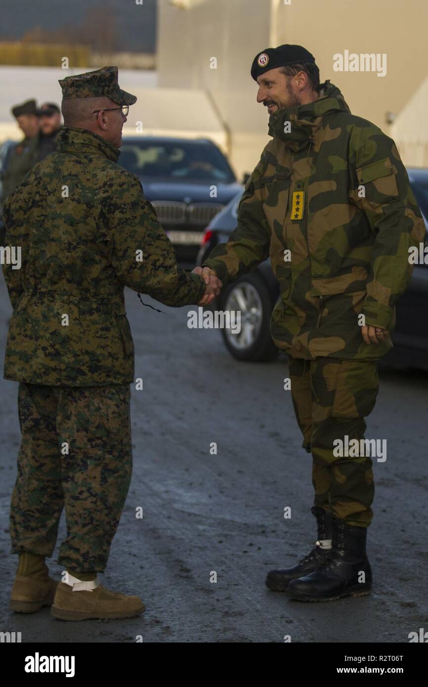 U.S. Marine Corps Lt. Gen. Robert F. Hedelund, the commanding general of II Marine Expeditionary Force, shakes hands with Crown Prince Haakon of Norway before touring along with him around Vaernes Air Station, Norway, during Exercise Trident Juncture 18, Nov. 7, 2018. Trident Juncture 18 enhances the U.S. and NATO Allies’ and partners’ abilities to work together collectively to conduct military operations under challenging conditions. Stock Photo