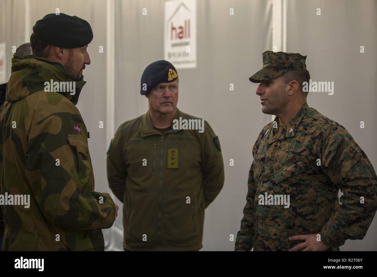 Crown Prince Haakon of Norway (left) speaks with U.S. Marine Corps Col. Frank N. Latt (rigtht), the assistant wing commander of 2nd Marine Aircraft Wing, while touring around the living quarters during Exercise Trident Juncture 2018 at Vaernes Air Station, Norway, Nov. 2018. Trident Juncture 18 enhances the U.S. and NATO Allies’ and partners’ abilities to work together collectively to conduct military operations under challenging conditions. Stock Photo
