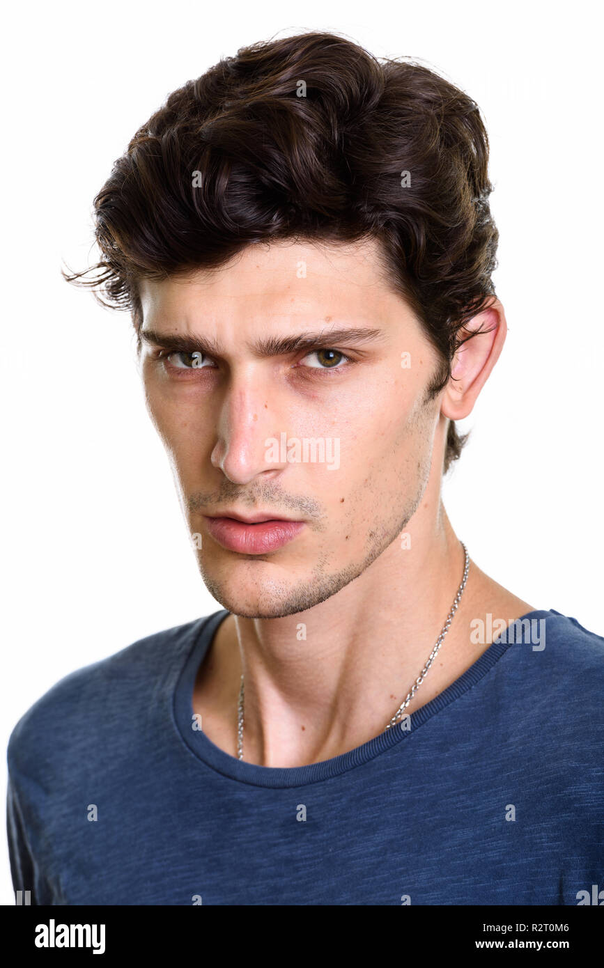 Face of young handsome man looking angry Stock Photo