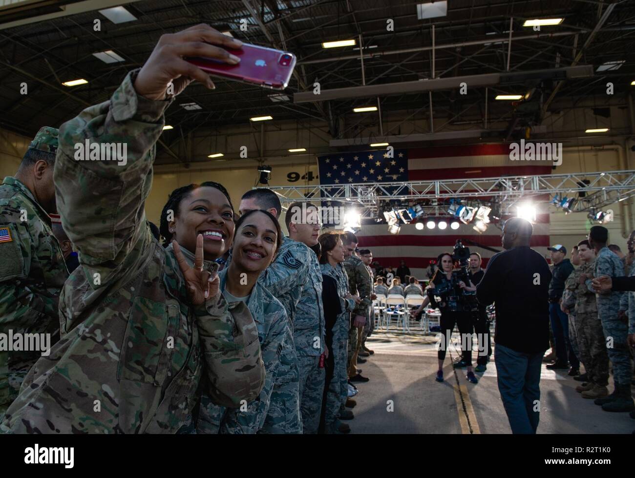 An Airman takes a photo during an ESPN First Take live show at Luke Air Force Base, Ariz., Nov. 9, 2018. Before starting the show, Airmen had the opportunity to meet and interact with the show hosts and take pictures. Stock Photo