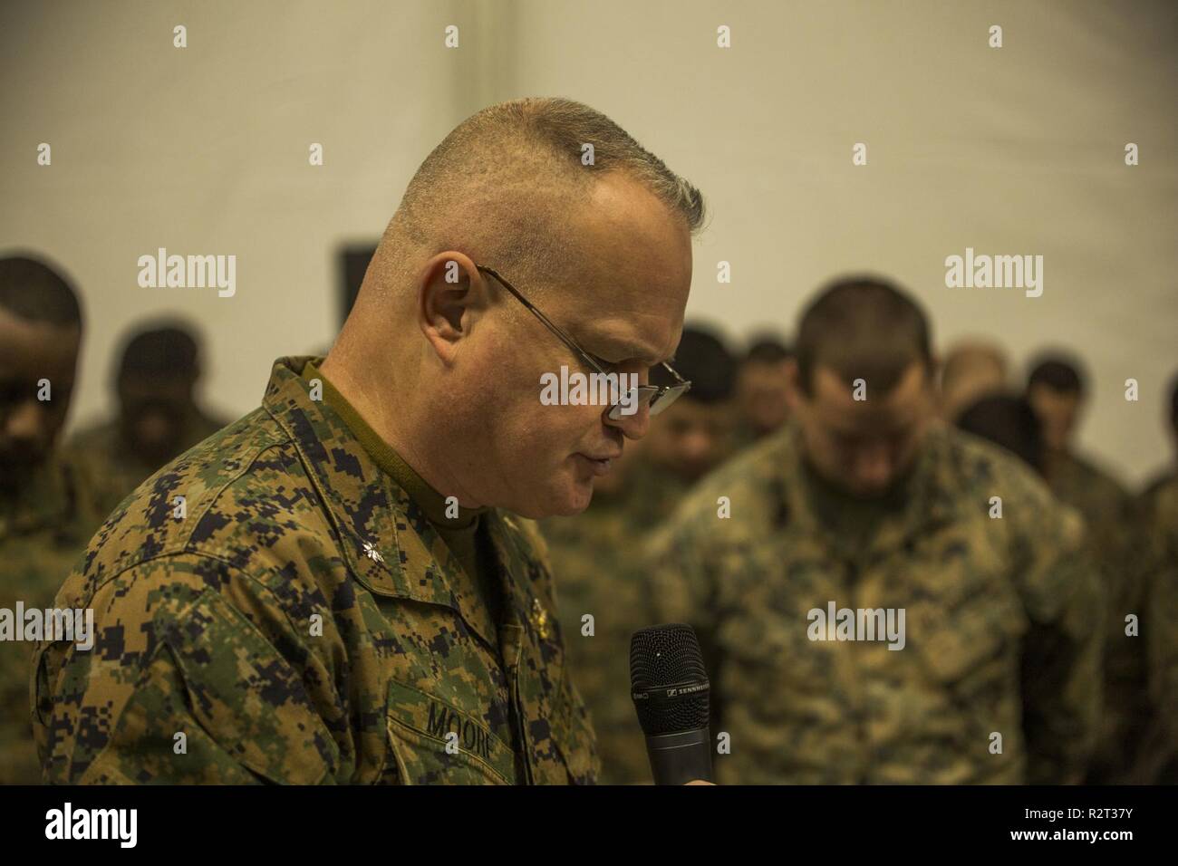 U.S. Navy Chaplain Commander Robert Moore with II Marine Expeditionary Force gives the invocation during a cake cutting ceremony celebrating the Marine Corps’ 243rd birthday on at Vaernes Air Station, Norway, Nov. 10, 2018. The ceremony is held at the conclusion of Exercise Trident Juncture 18, an exercise in place to enhance the U.S. and NATO Allies’ and partners’ abilities to work together collectively to conduct military operations under challenging conditions. Stock Photo