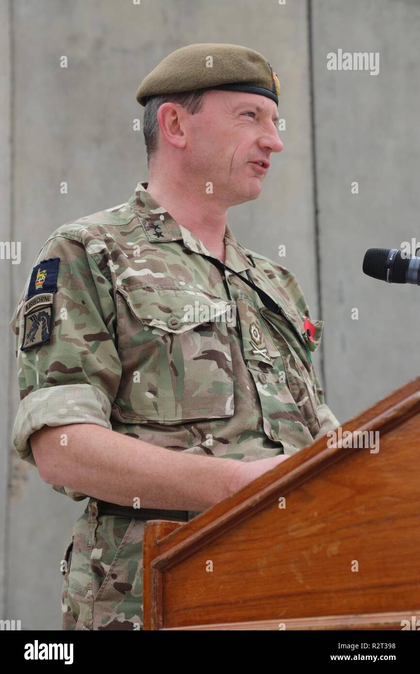 British Army Maj. Gen. Christopher Ghika, deputy commander for Strategy and Information Combined Joint Task Force - Operation Inherent Resolve (CJTF-OIR), speaks before a gathering of Coalition forces at the Armistice Ceremony at Union III, Baghdad on Nov. 11, 2018. Armistice Day is observed annually on Nov. 11 and coincides with Veterans Day and Remembrance Day. Veterans Days honors all American Veterans, and Remembrance Day honors those members of the armed forces who died while serving in the line of duty.  Today, the Global Coalition to defeat ISIS has grown to 74 member nations and five i Stock Photo