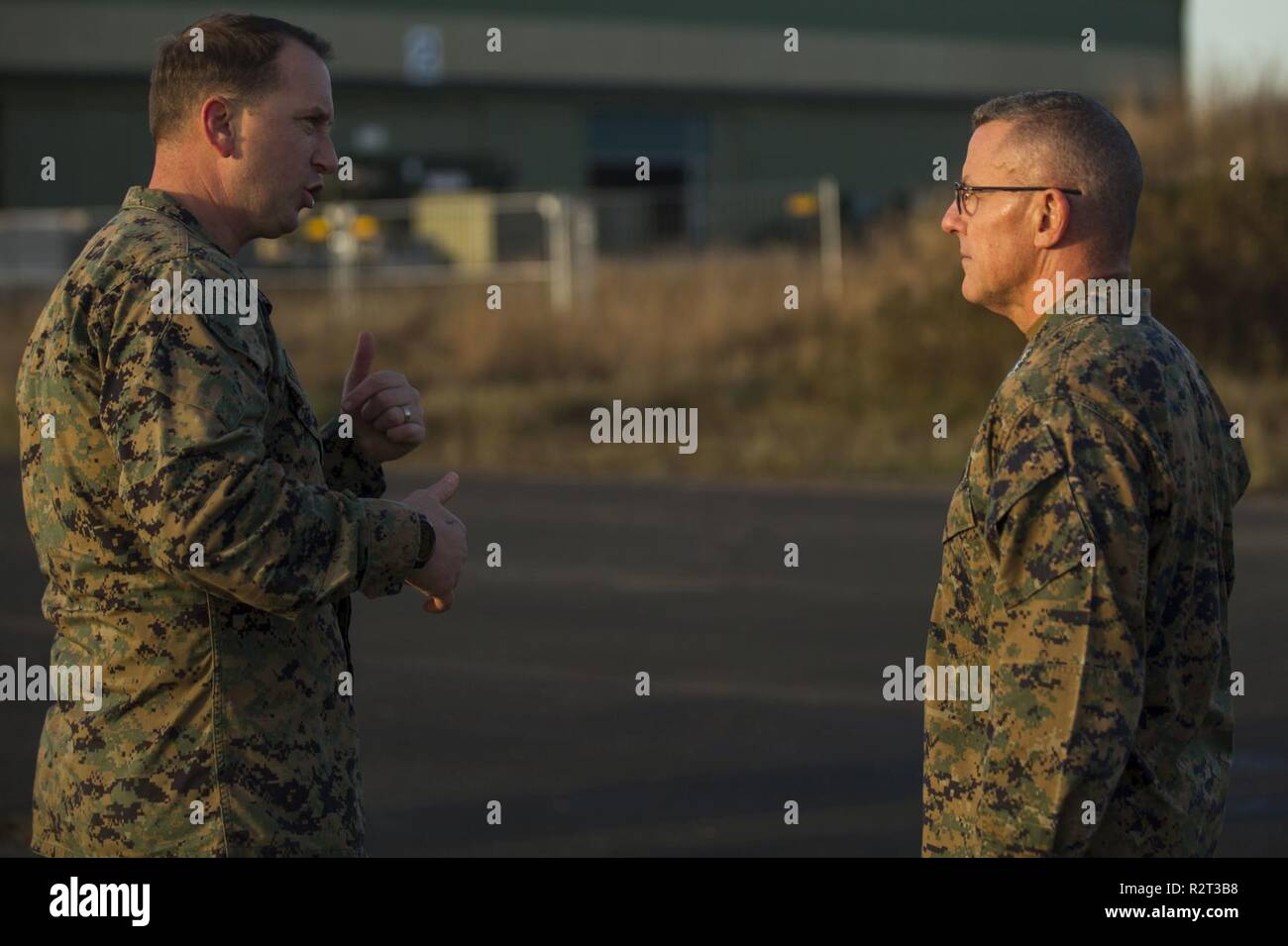 U.S. Marines Chief Warrant Officer 4 Clint Runyon, a visual information officer with Communication Strategy and Operations, II Marine Expeditionary Force (II MEF), speaks with Lt. Gen. Robert F. Hedelund, the commanding general of II MEF during Exercise Trident Juncture 18 at Vaernes Air Station, Norway, Nov. 7, 2018.  Trident Juncture 18 enhances the U.S. and NATO Allies’ and partners’ abilities to work together collectively to conduct military operations under challenging conditions. Stock Photo