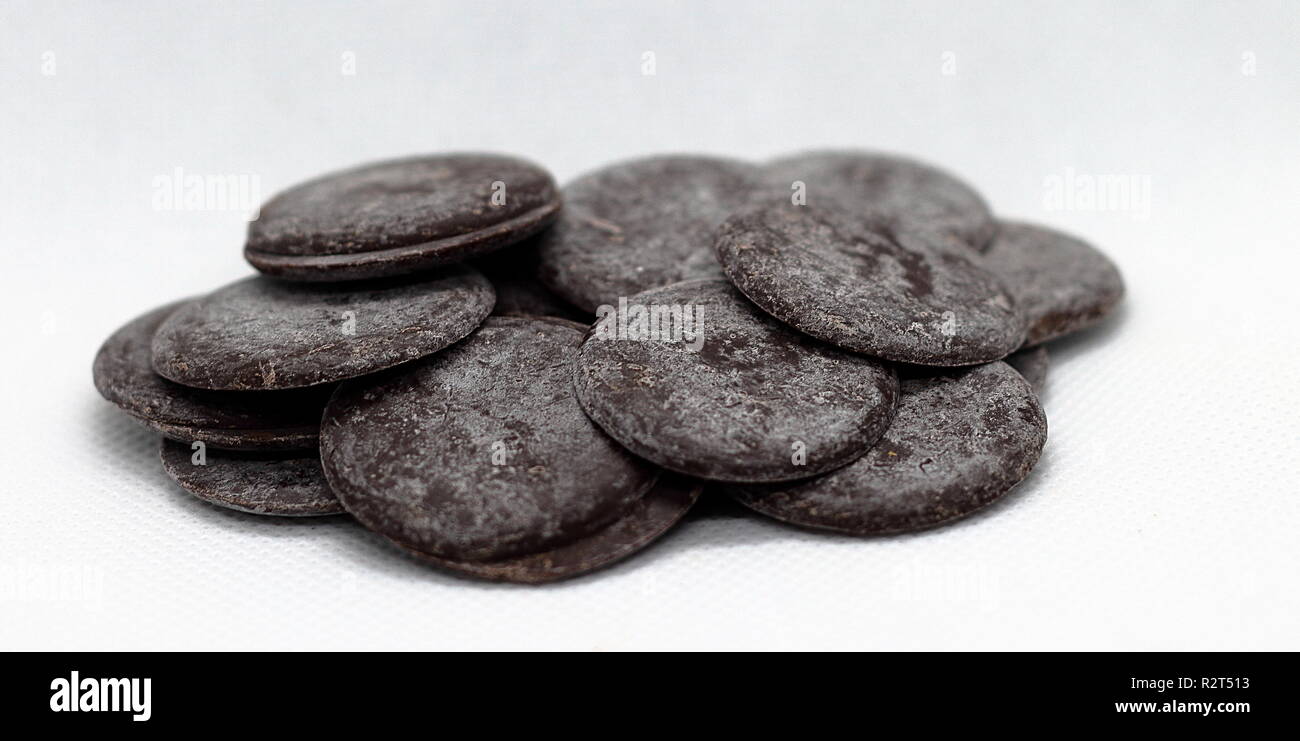 Dark edged chocolate chips isolated over white background Stock Photo