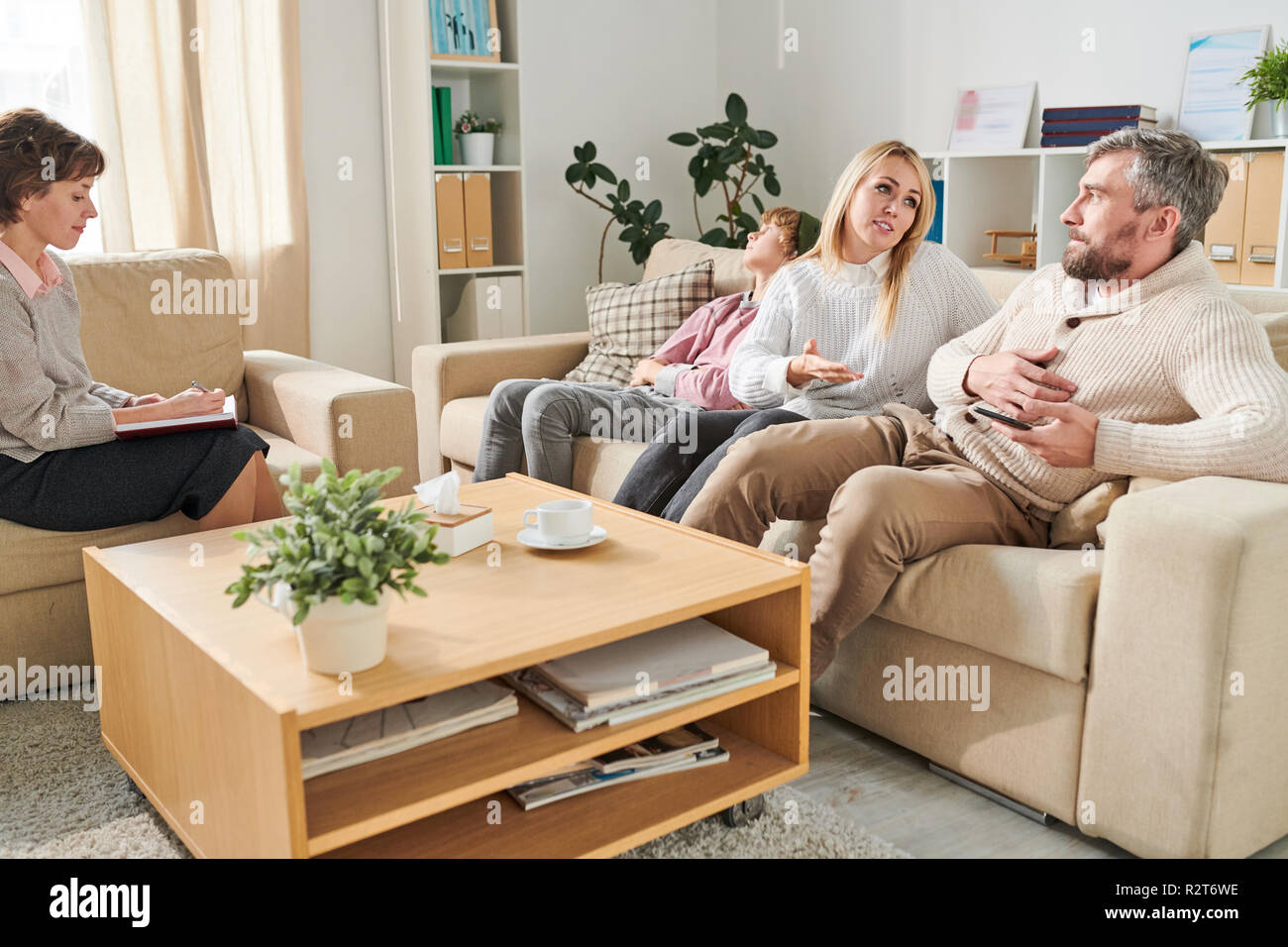 Family with teenager visiting psychologist Stock Photo