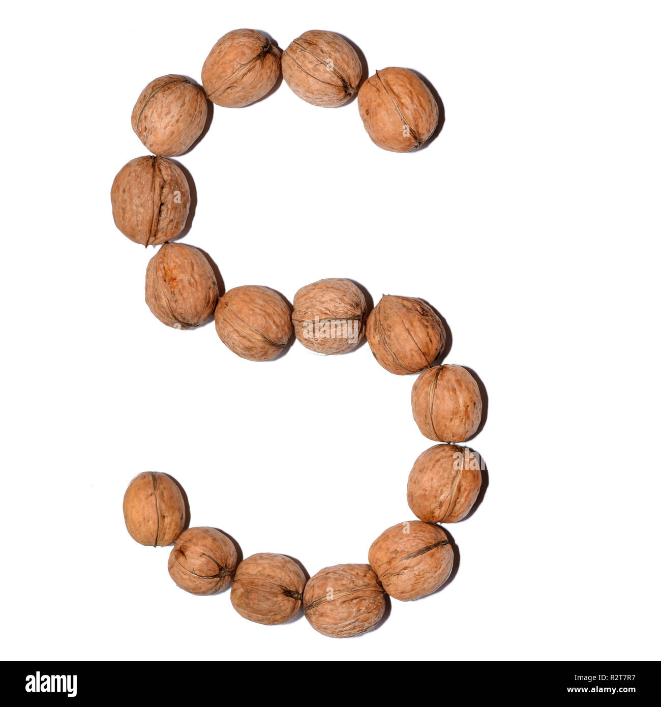 Letter S made with nuts to form a letter of the alphabet. Fruit letters on a white background. Stock Photo