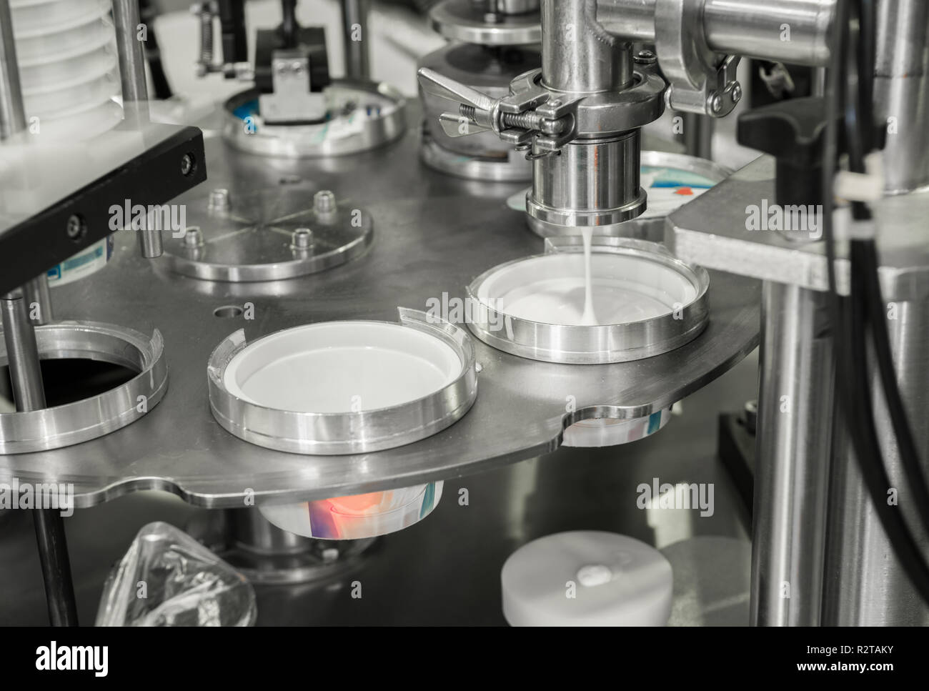 production and bottling of yogurt in plastic cups. equipment at the