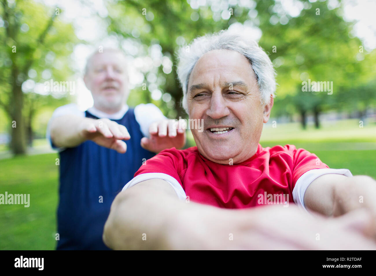 Active senior men exercising in park Stock Photo