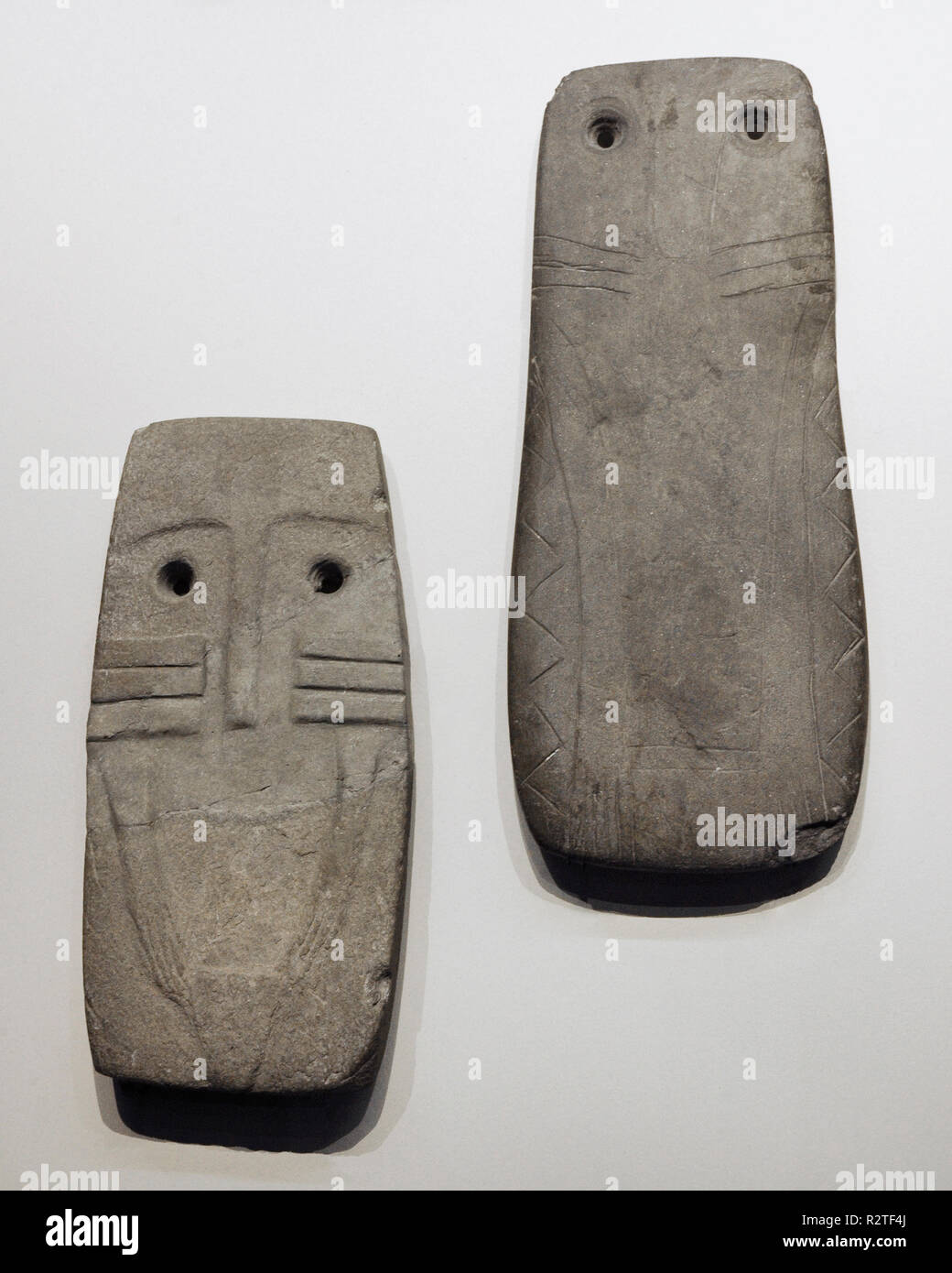 Left: Idol-plate anthropomorphic. 3750-2500 BC. Chalcolithic. From the Dolmen of Garrovillas (Garrovillas de Alconetar, province of Caceres, Extremadura). Right: Idol-plate anthropomorphic. Chalcolithic. From Barbacena (Elvas, Portugal). National Archaeological Museum. Madrid. Spain. Stock Photo