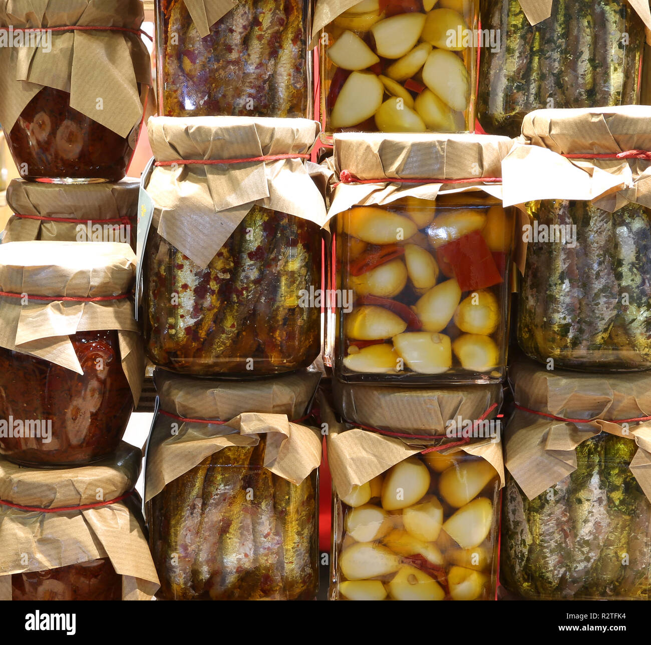 background of many glass jars with typical italian food from Calabria Region garlic anchovies