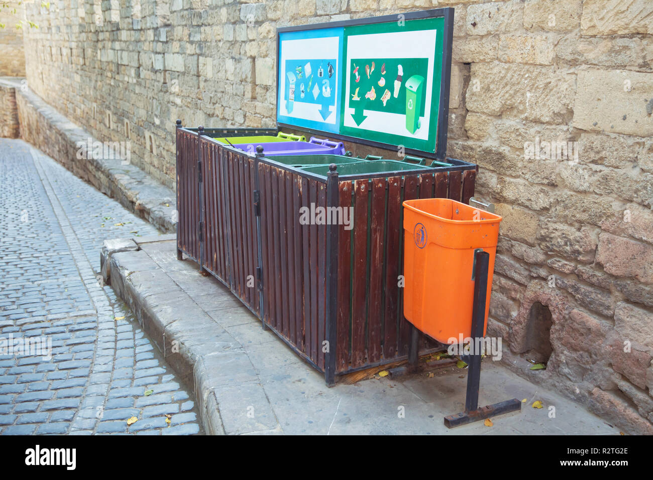 Different recycle bins on stand near footpath . Food waste . nonfood