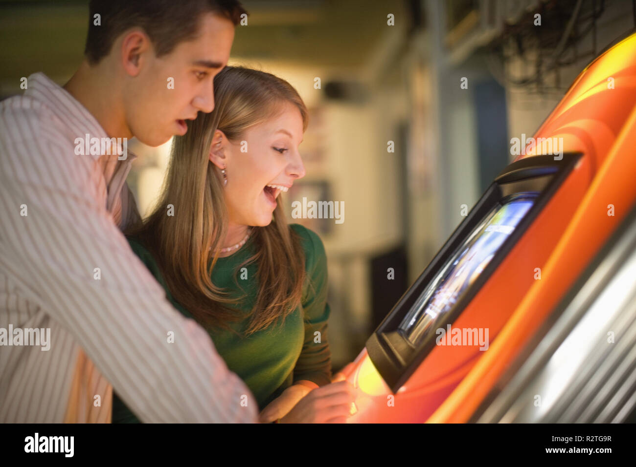Young couple playing an arcade game. Stock Photo