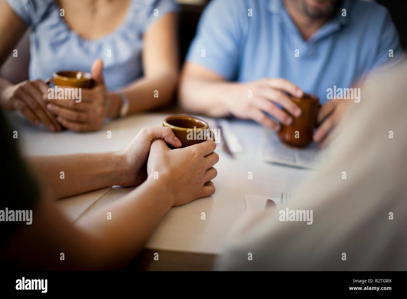 Group of friends meeting for coffee at a local diner. Stock Photo