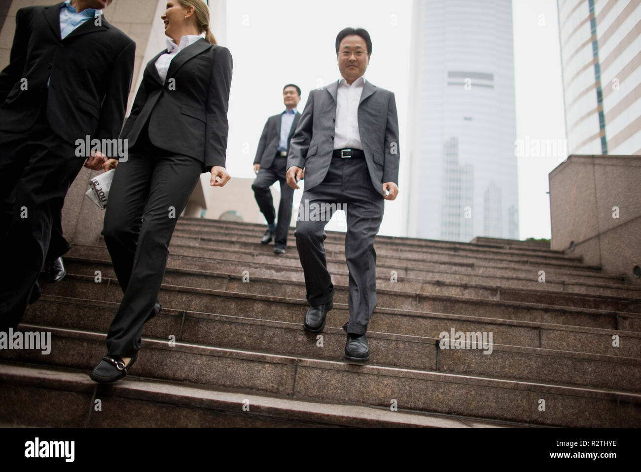 Businessmen walking down stairs hi-res stock photography and images - Alamy