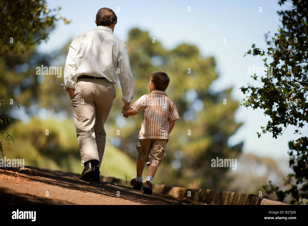 Father and son walk hand in hand. Stock Photo