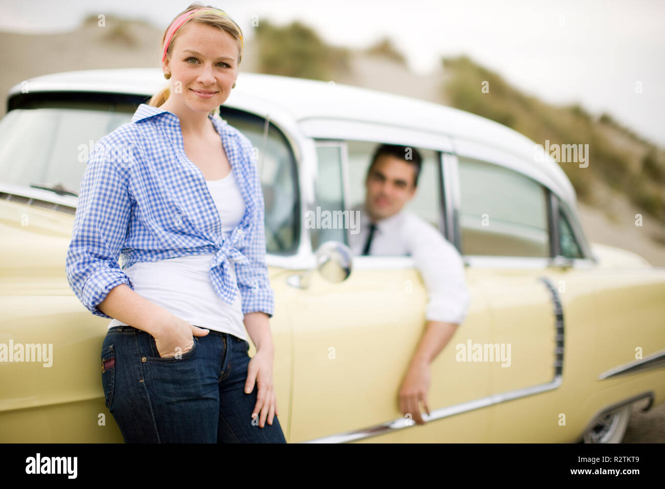 Young couple posing with a vintage car Stock Photo