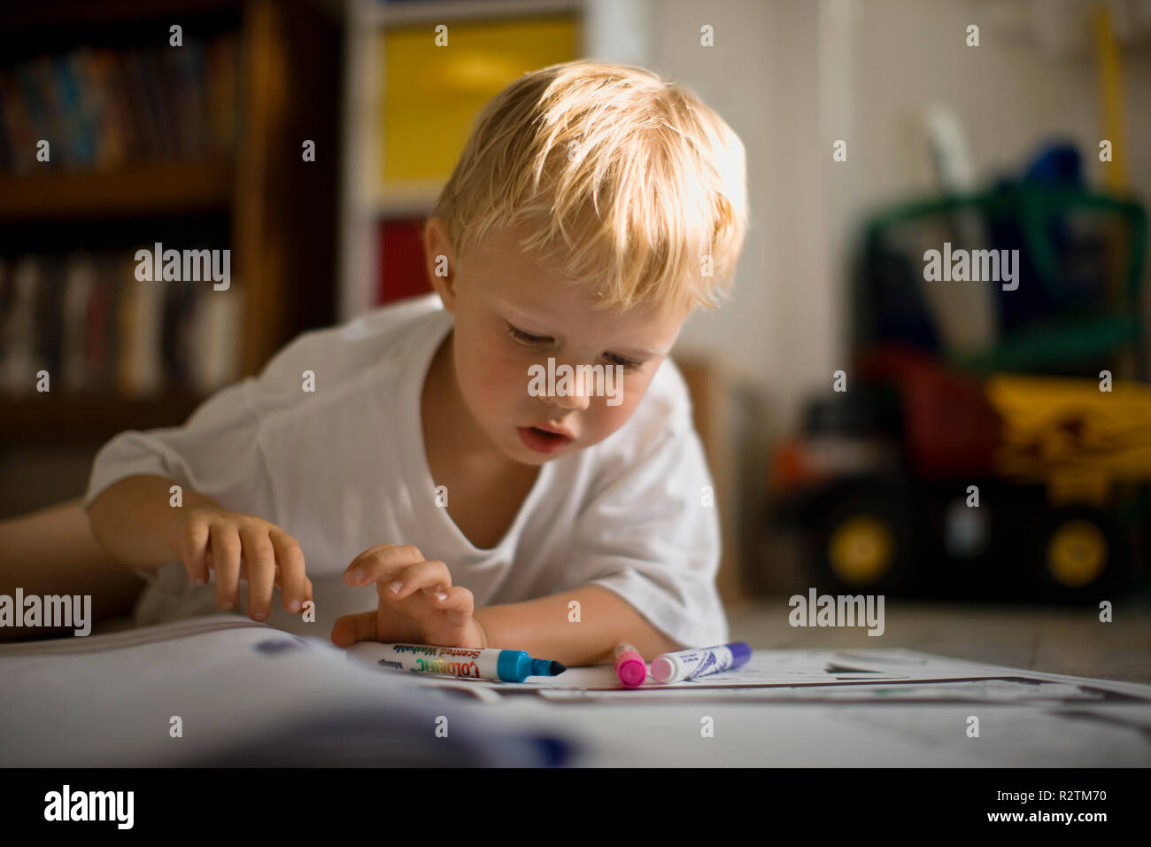 A young boy colouring in at home. Stock Photo