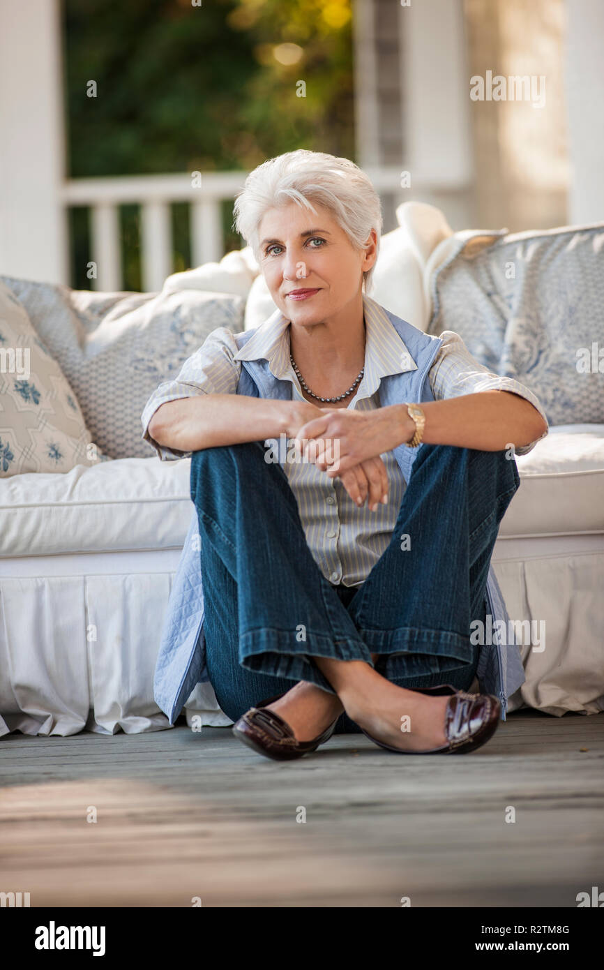 Portrait of a mature woman sitting on her porch Stock Photo - Alamy