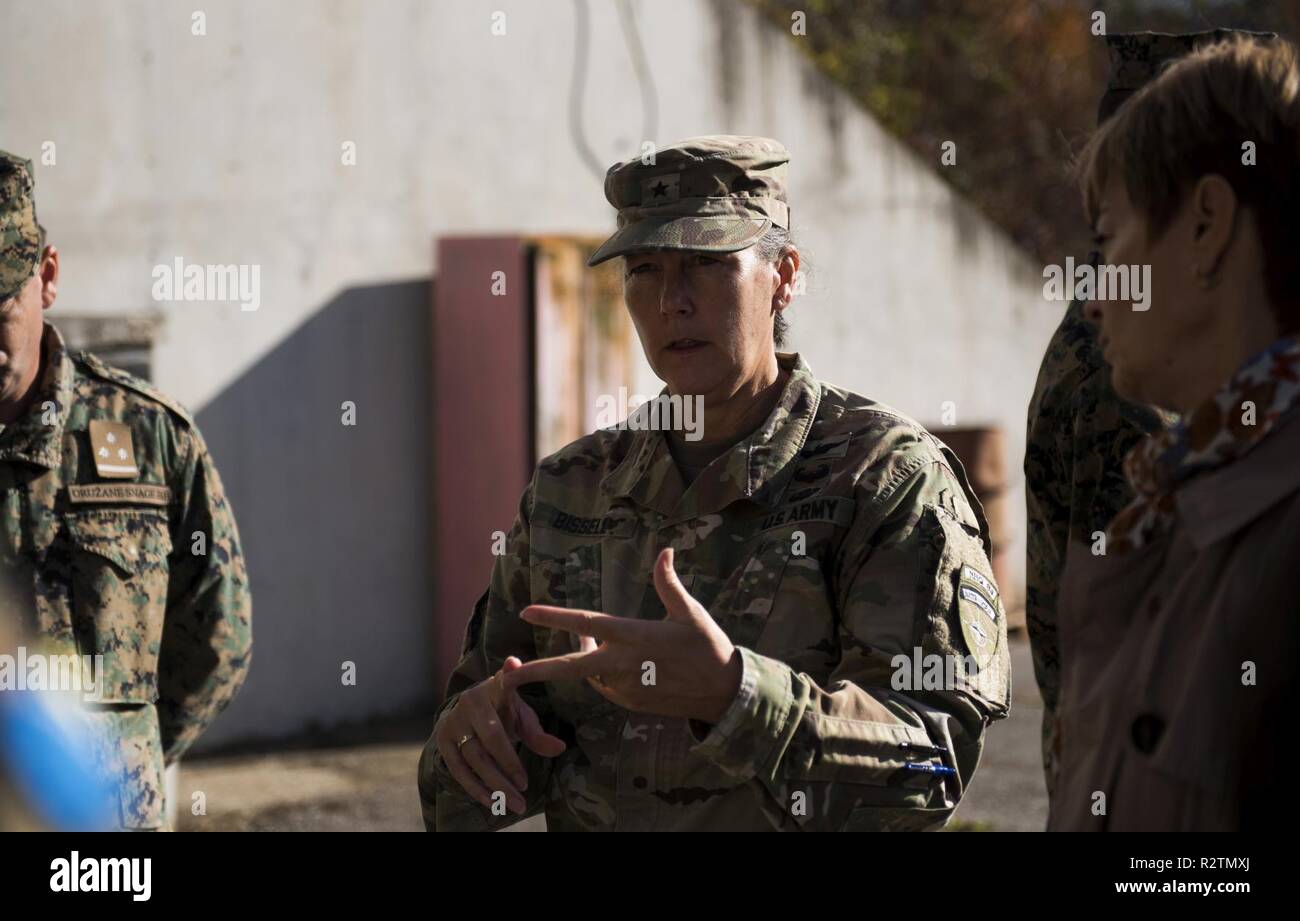 U.S. Army Brig. Gen. Marti Bissell, NATO Headquartes Sarajevo commander, speaks with Armed Forces of Bosnia and Herzegovina soldiers during a tour of a munitions storage site in Tuzla, BiH, Oct. 31, 2018. NHQSa staff visited military installations in the area to familiarize themselves with 5th Infantry Brigade's mission and capabilities. Stock Photo