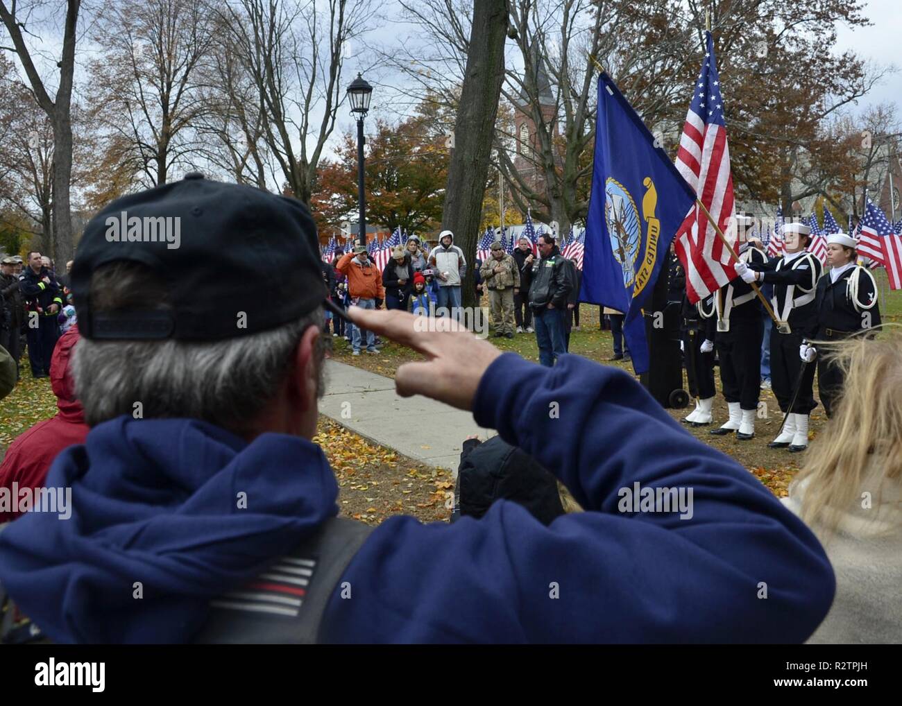 WEST SPRINGFIELD, Mass. (Nov. 10, 2018) Sailors assigned to USS Constitution present the colors during the national anthem as a part of the West Springfield, Mass., annual Veterans Day parade. Stock Photo