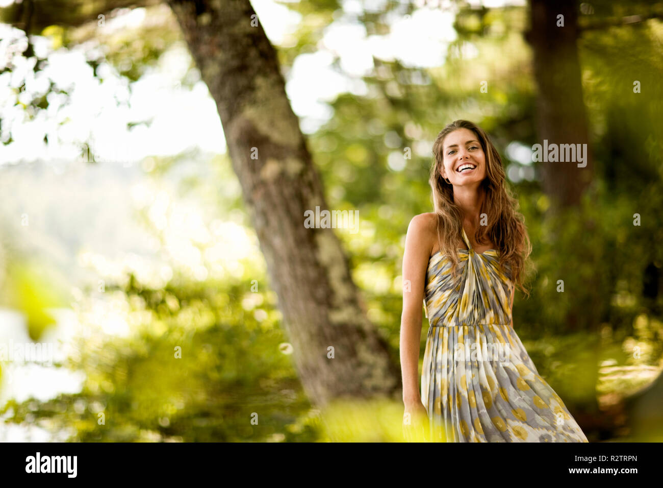 Portrait of woman in green dress in the woods Stock Photo - Alamy